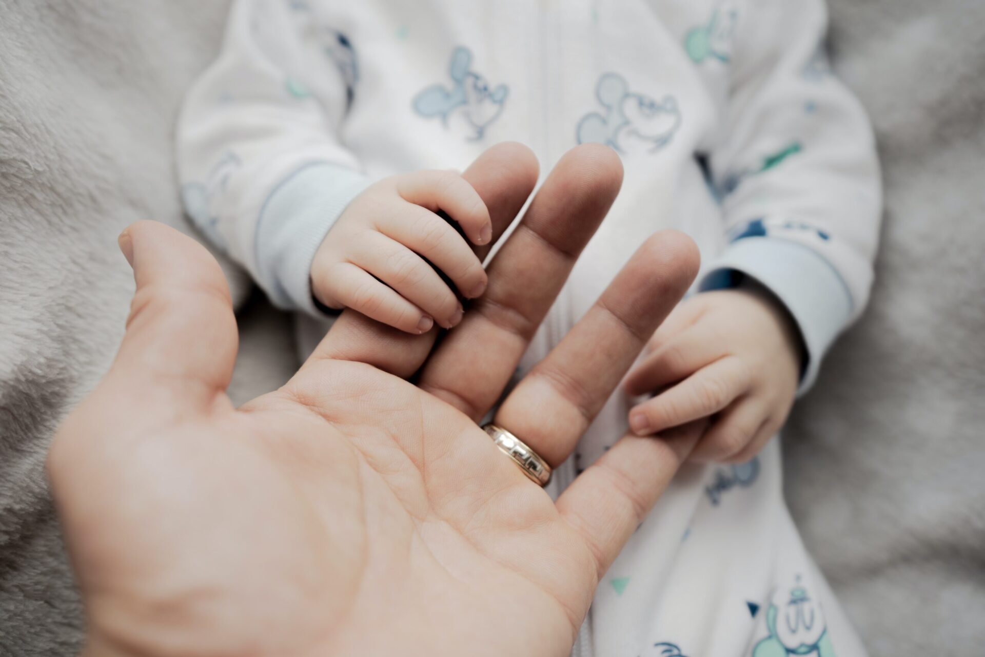 a person holding a babys hand